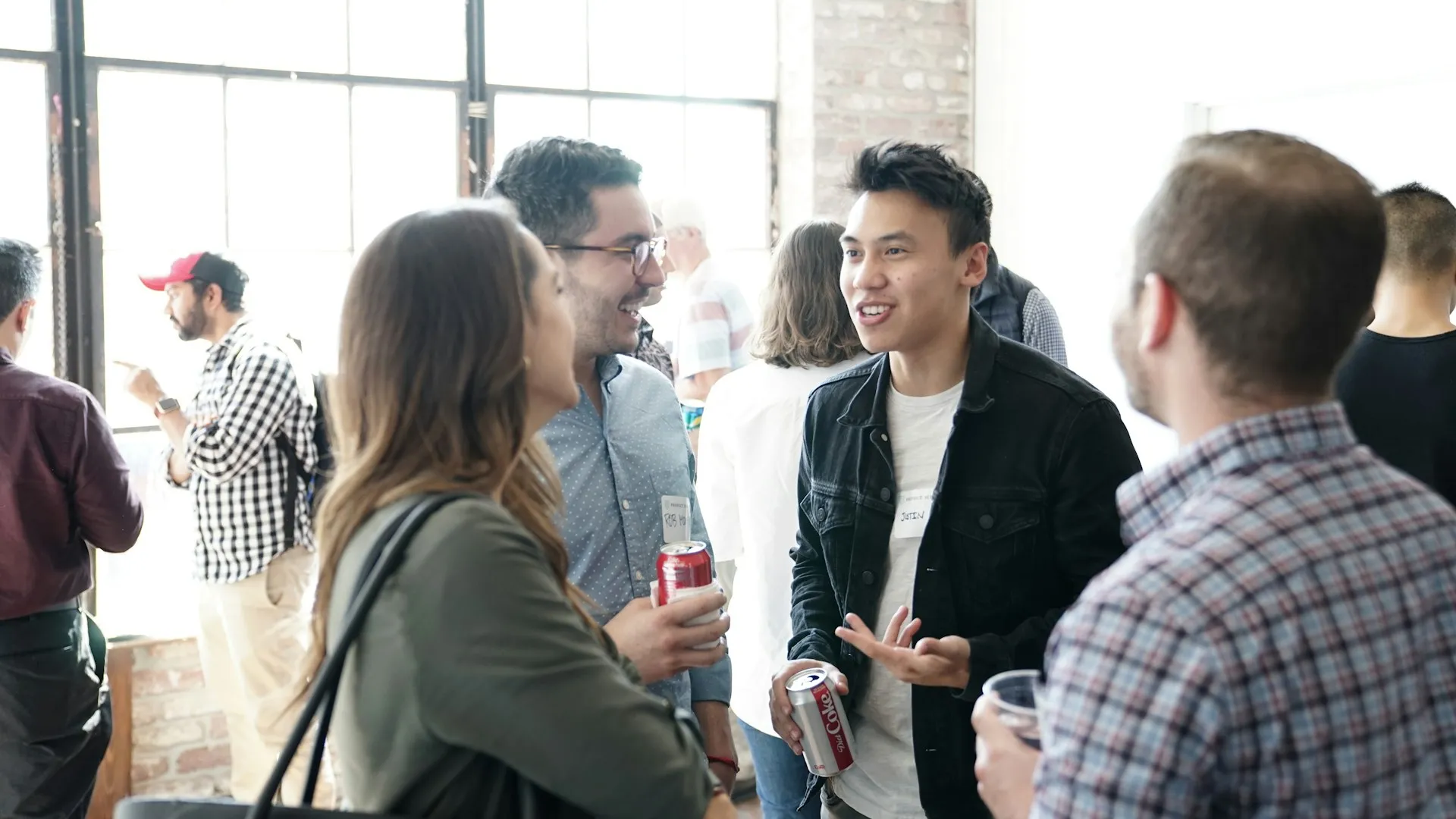 Bir networking buluşmasında ayakta sohbet eden konuklar